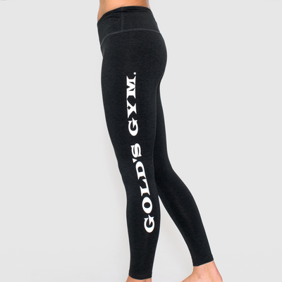 model of model wearing advance ladies legging in black heather. golds gym printed on left leg vertically in white.