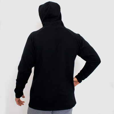 back view photo of model wearing advance mens fleece hoodie in black. hoodie worn up.