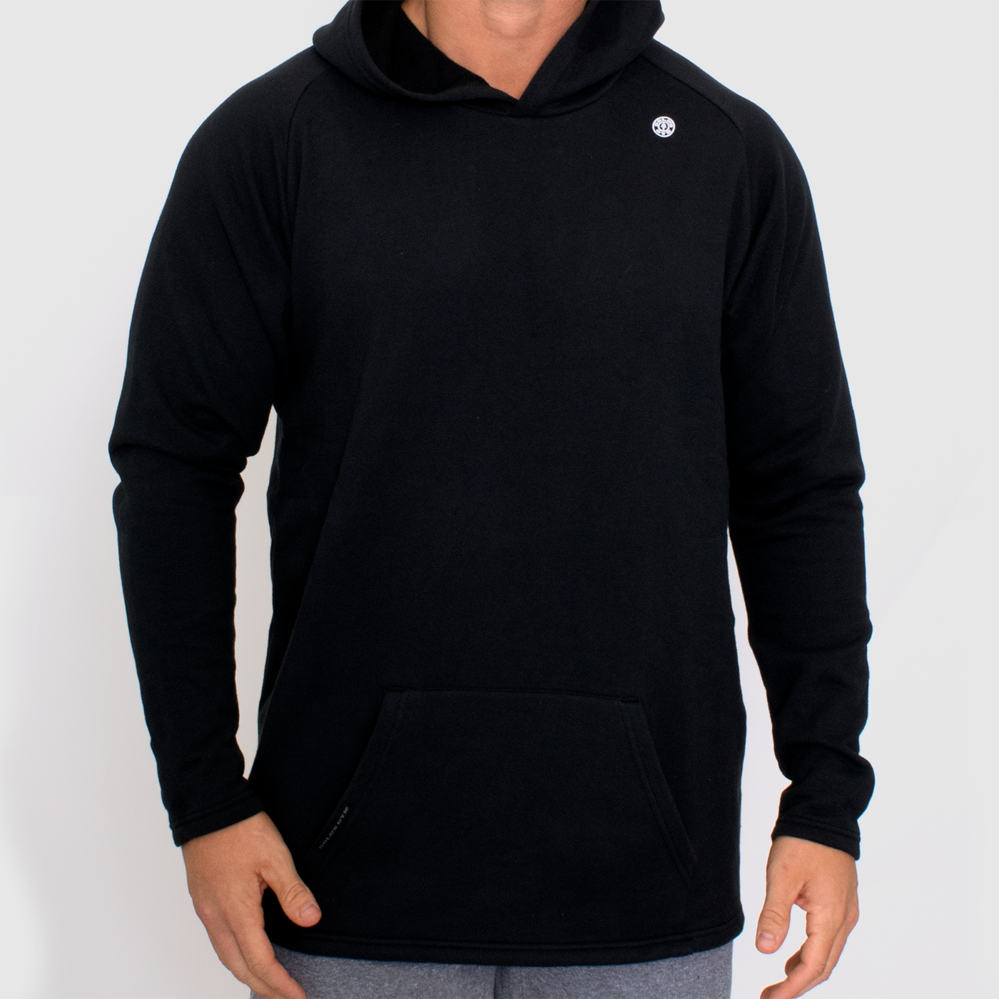 detail photo of model wearing advance mens fleece hoodie in black. hoodie worn up.