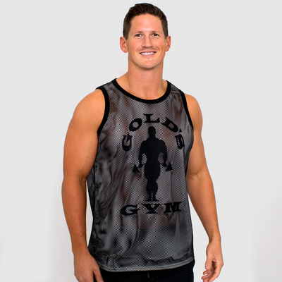 photo of model wearing mens double mesh tank in white black. golds gym muscle joe logo printed on front in black.