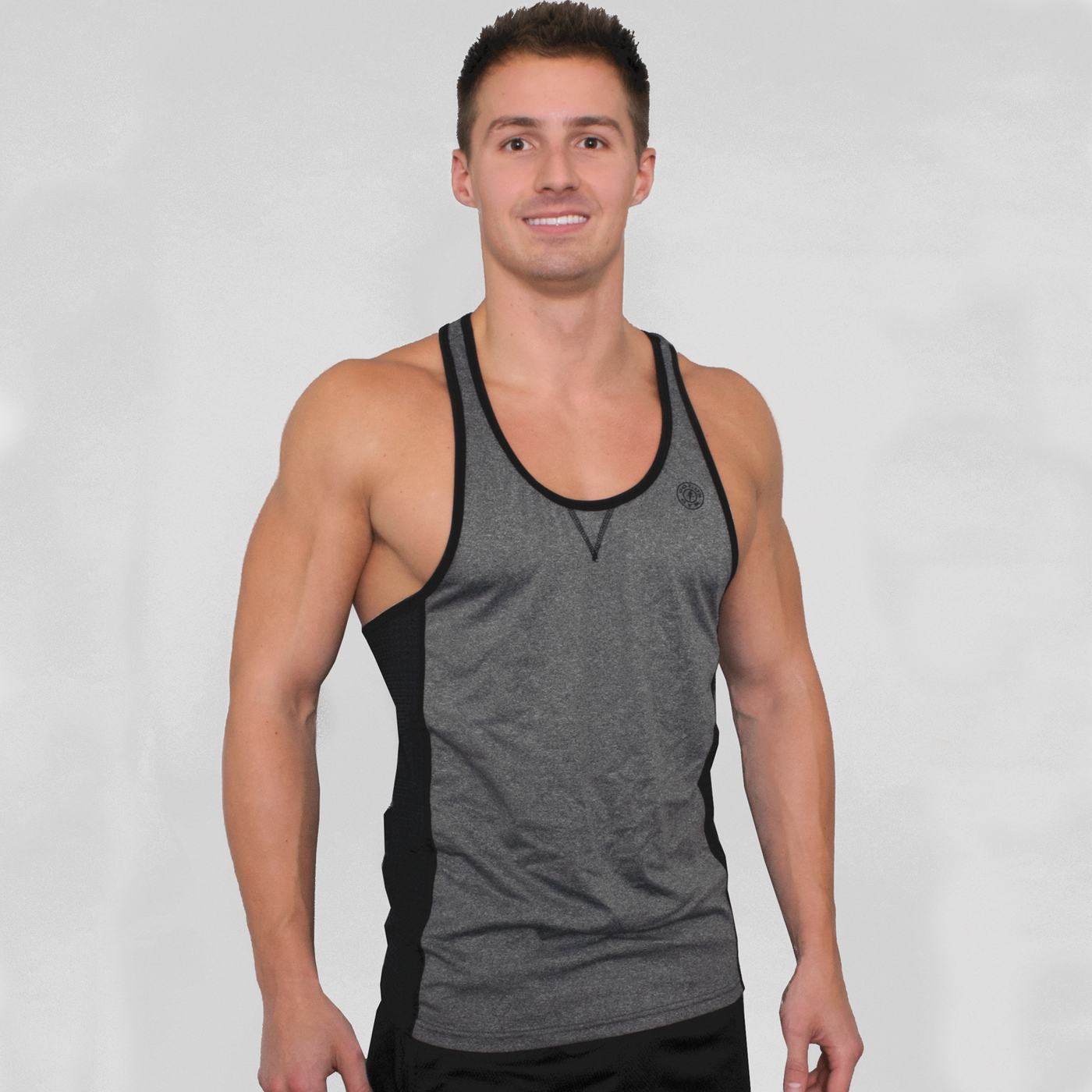 photo of modal wearing advance performance stringer in athletic heather. golds gym weight plate logo in black on upper left chest. black trim around arm and neck holes. black stripes on sides. stitched v under neck line. 