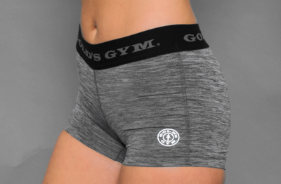 photo of model wearing advance hot short in metal heather. golds gym printed on waistband. gold gym weight plate logo printed on left leg in white. 